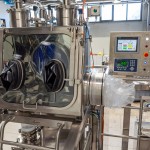 Drum Discharging Glove Box Installed on Mezzanine with Filters, Air Extraction, Continuous Liner Systems, and Touch Panel Display